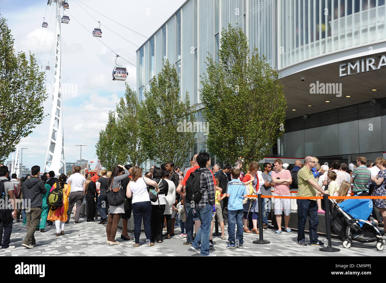 Passengers queue to travel across the Thames between the 02 Arena in   Greenwich and the Excel exhibition centre at the Royal Docks in east London  in Britain's new Thames Cable Cars. 30 June 2012. Stock Photo