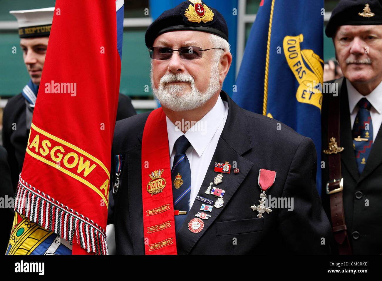 30 June 2012. Armed Forces Day. Glasgow, Scotland, UK, John Mortimer MBE and retired member of the Merchant Navy, on parade with his flag and MBE medal at the start of the military parade from Holland Street, Glasgow. Stock Photo