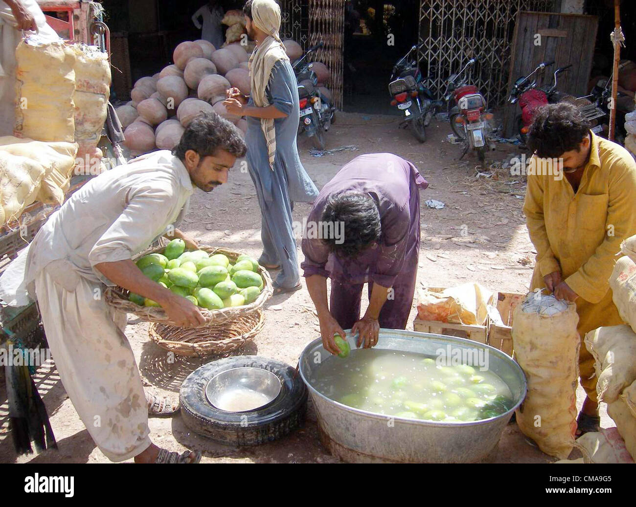 Labours washing mangoes before dispatching at Fruit market in Hyderabad