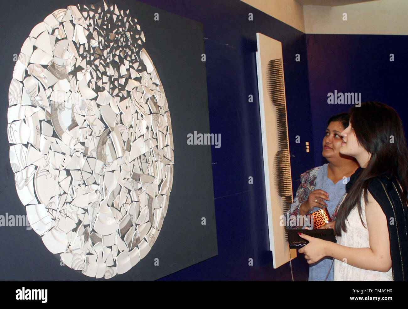 Students take keen interest in a painting during an exhibition