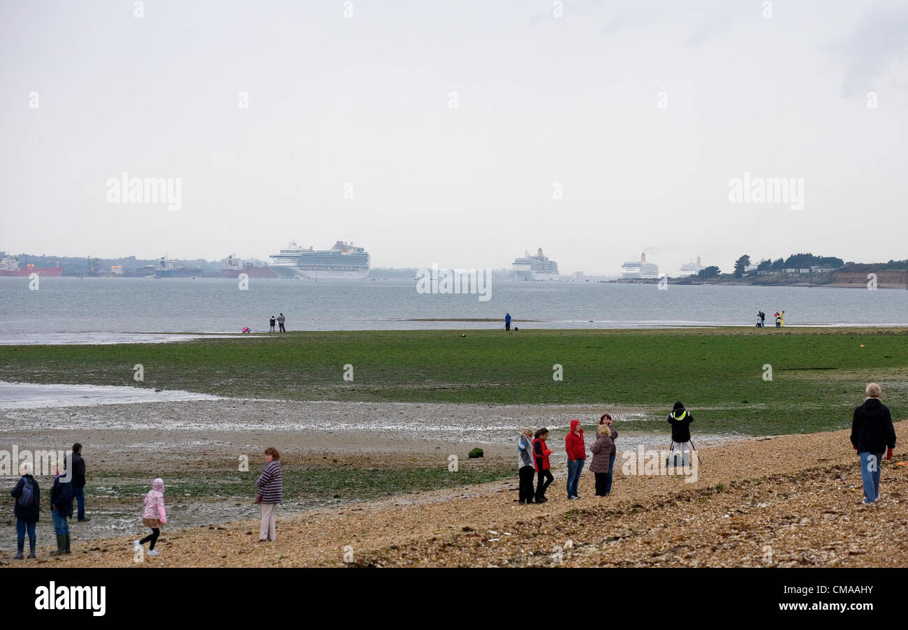 Titchfield, UK. Tuesday 3rd July 2012. Crowds watch the P&O 175th Anniversary celebrations with 7 large cruise ships sailing through the solent from Hill Head in Titchfield. Stock Photo