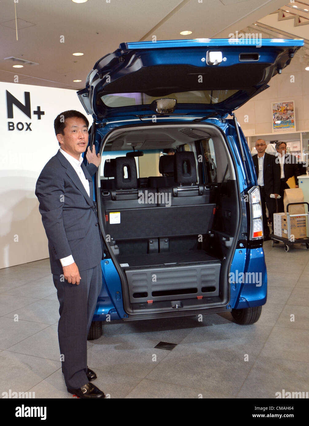 July 5, 2012, Tokyo, Japan - Sho Minekawa, Honda Motor Co.s chief operating officer for regional sales operations in Japan, poses with an N BOX + during a launch of the second model of the new mini-vehicle N series at its head office in Tokyo on Thursday, July 05, 2012. The N BOX realizes one of the largest interior spaces among all mini-vehicles on the market by adopting the newly-designed platform and powerplant. (Photo by Natsuki Sakai/AFLO) Stock Photo