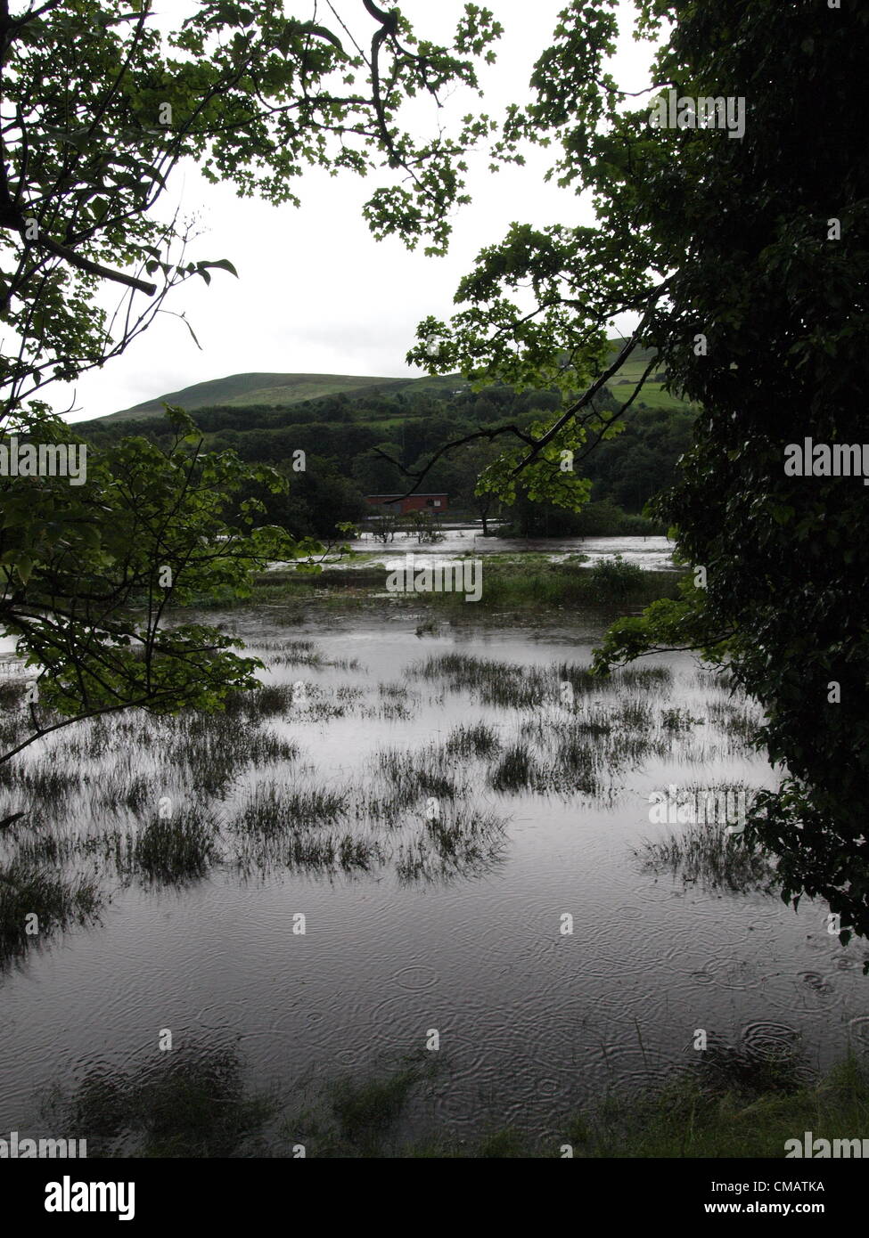 Flood water covers fields as River Tame bursts it's banks in Well-i-hole area of Saddleworth in Oldham, UK, on Friday 6th July 2012 Stock Photo