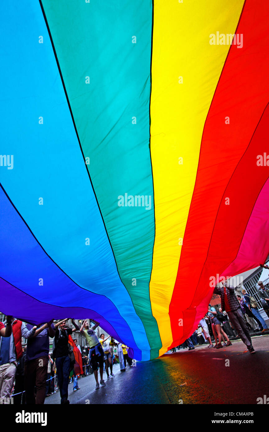 London, UK. 7th July 2012. The rainbow flag and participants marching in World Pride 2012, London, England Stock Photo