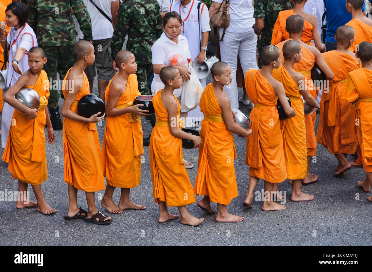 Some of the 12,600 monks at an Alms giving ceremony in downtown Bangkok, Thailand on July 7th, 2012. These monks are celebrating 2,600 years of the Buddha's enlightenment. Stock Photo