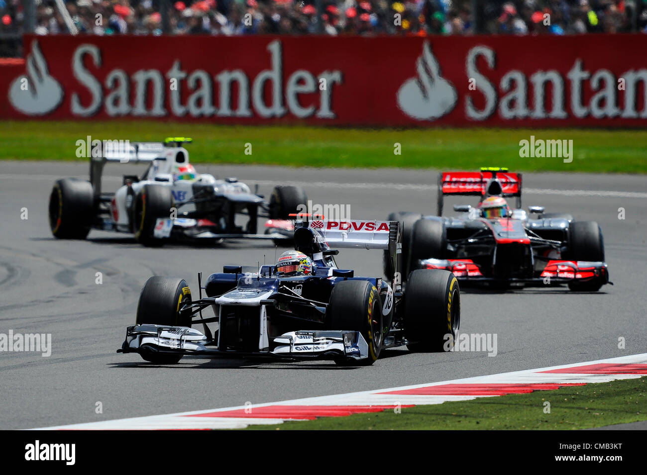 08.07.2012 Towcester, England. Pastor Maldonado of Venezuela and Williams F1 Team and Lewis Hamilton of Britain and Vodafone McLaren Mercedes in action during the Race at the Santander British Grand Prix, Round 9 of the 2012 FIA Formula 1 World Championship at Silverstone Circuit. Stock Photo