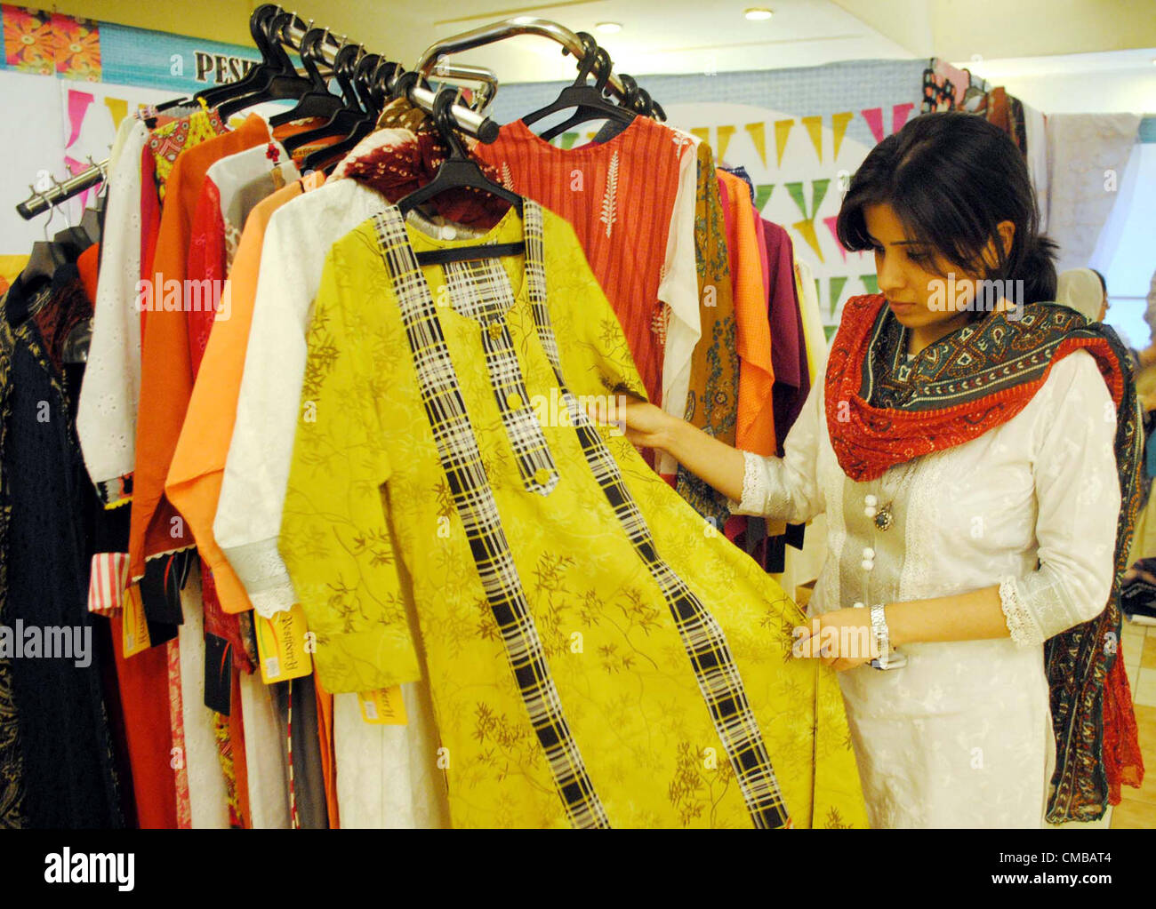 Women take keen interest in fabrics at a stall during a fabric