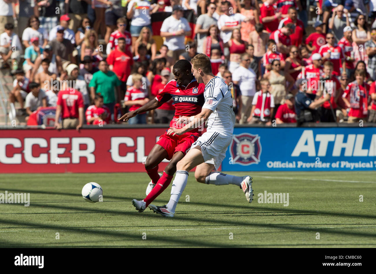 08.07.2012. Chicago, USA.  Bryan Gaul (white) battles Jalil Anibaba (red) for the ball. The LA Galaxy went on to defeat the Chicago Fire, 2-0 at Toyota Park, Bridgeview, Il Stock Photo