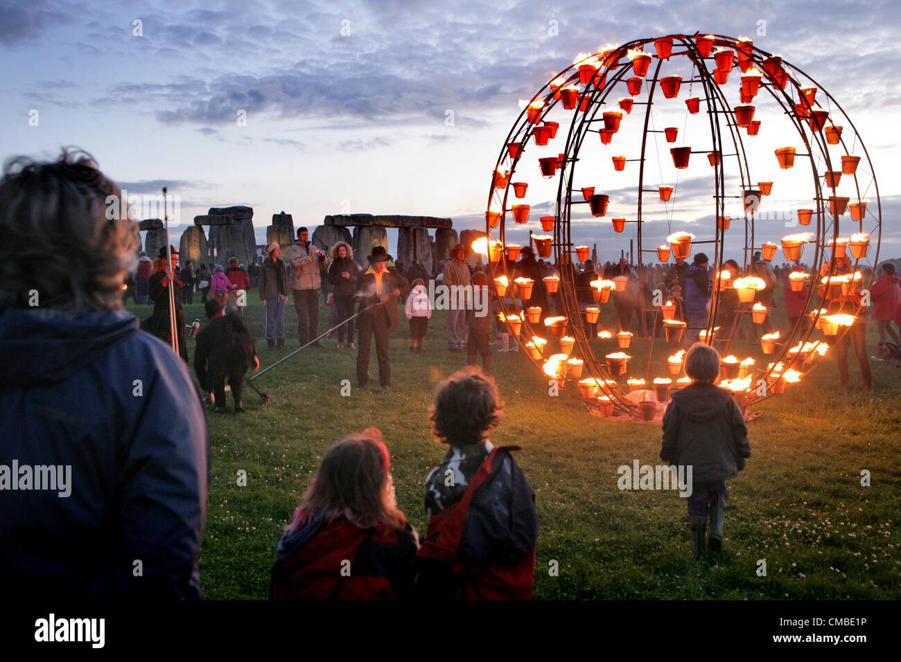 Wiltshire, UK. Tuesday 10th July 2012. Visitors get a close view of part of the Fire Garden at Stonehenge in Wiltshire, UK. French outdoor fire alchemists Compagnie Carabosse present the FIRE GARDEN at the World Heritage Site Stonehenge in Wiltshire on 10th - 12th July as part of the London 2012 Festival. Stock Photo