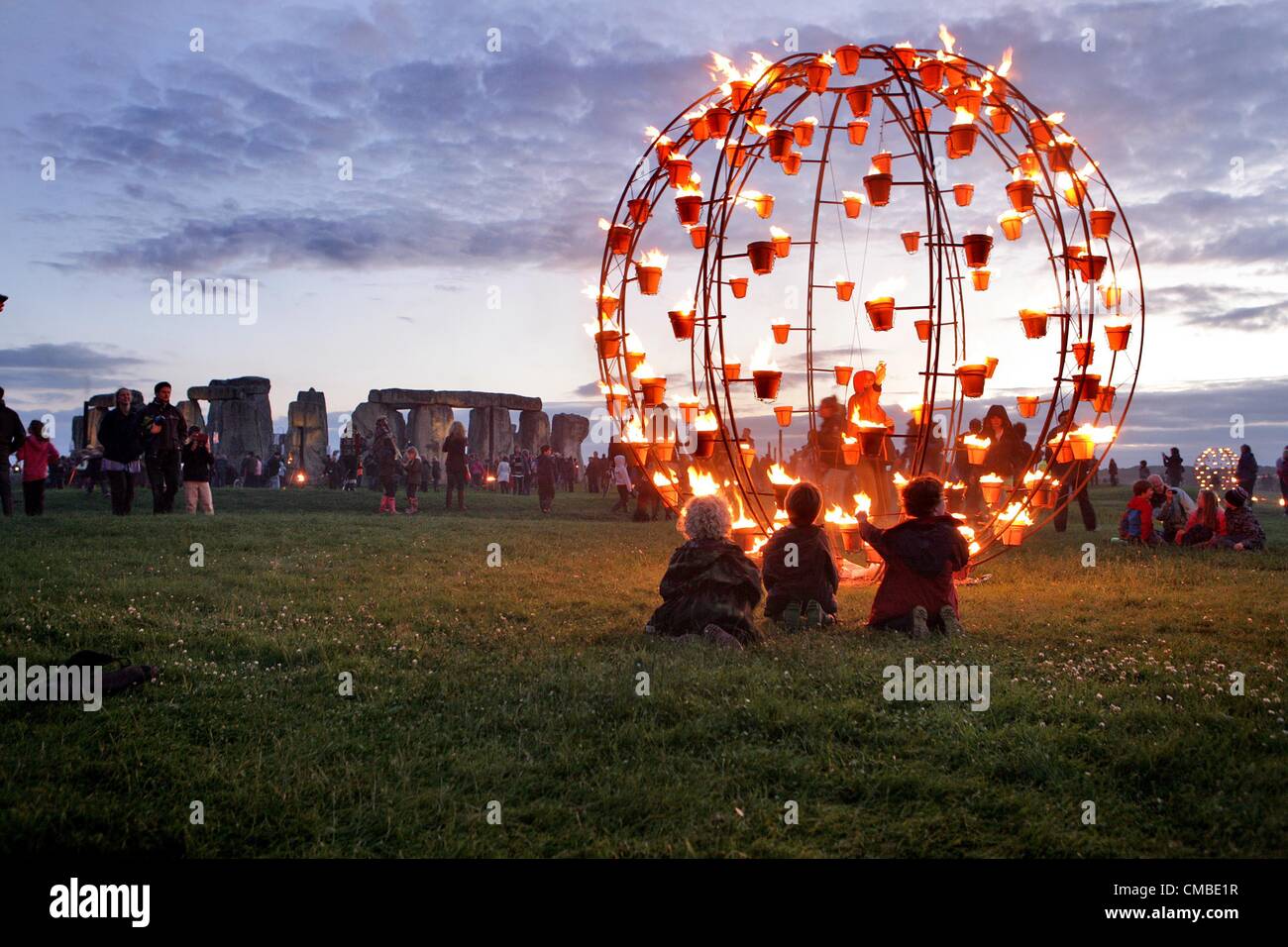 Wiltshire, UK. Tuesday 10th July 2012. Three children get a close view of part of the Fire Garden at Stonehenge in Wiltshire. French outdoor fire alchemists Compagnie Carabosse present the FIRE GARDEN at the World Heritage Site Stonehenge in Wiltshire on 10th - 12th July  as part of the London 2012 Festival. Stock Photo