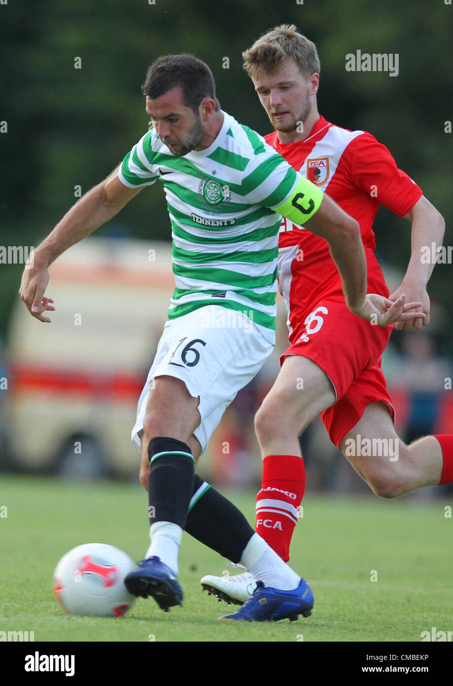 10.07.2012. Donauwoerth, Germany.  Glasgow's Joe Ledley (L) and Augsburg's Stephan Hain vie for the ball during a soccer test match between FC Augsburg and Celtic Glasgow in Donauwoerth, Germany, 10 July 2012. Stock Photo