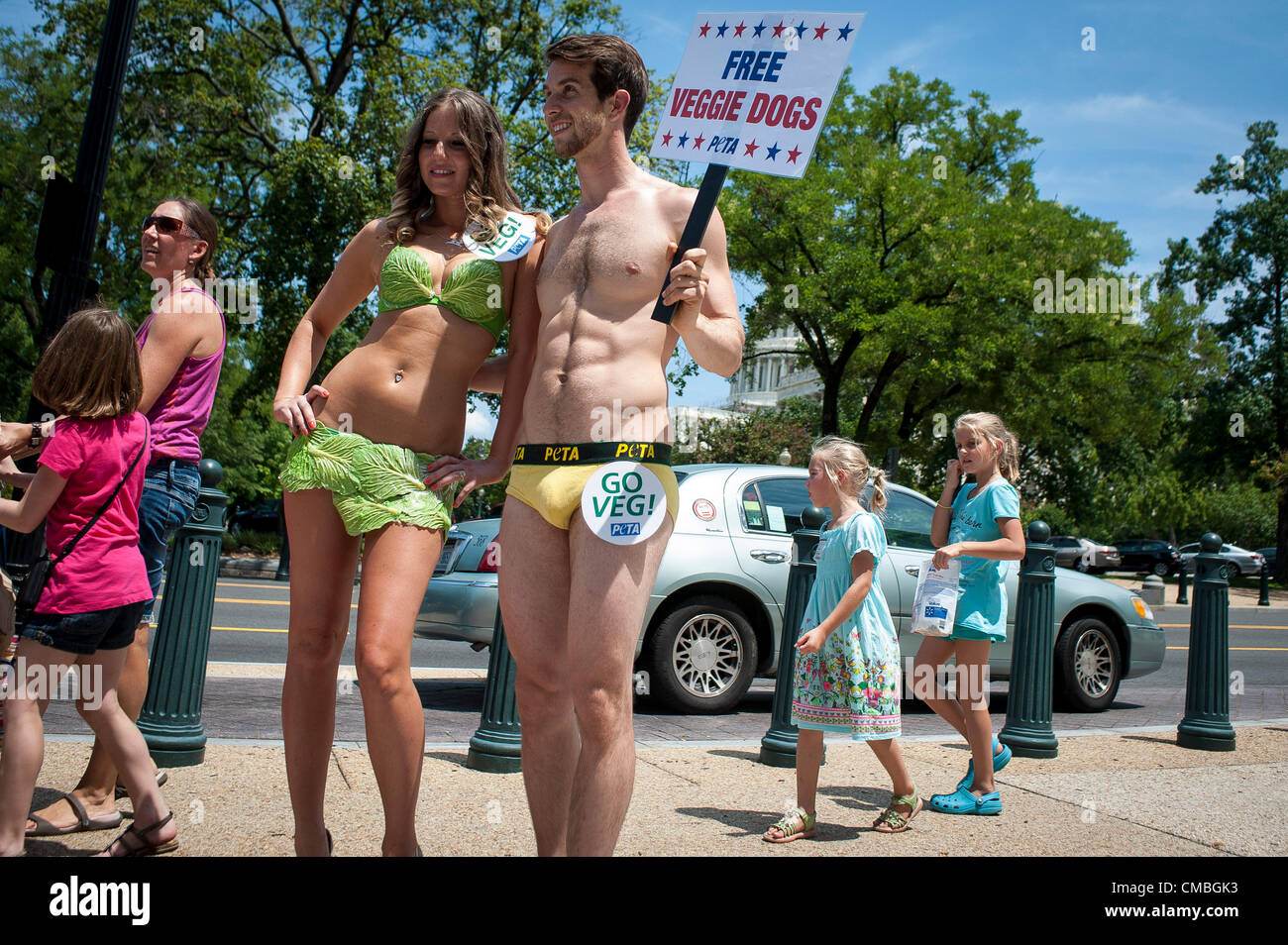 July 11, 2012 - Washington, District of Columbia, U.S. - PETA's (People for the Ethical Treatment of Animals) ''lettuce lady,'' TESSA CALLAn and ''banana boy'' ZACHARY KOVAL pose for photos outside the Rayburn House Office Building in Washington, D.C. in celebration of National Veggie Hot Dog Month. PETA aims to draw attention to foods made without animal products (Credit Image: © Pete Marovich/ZUMAPRESS.com) Stock Photo