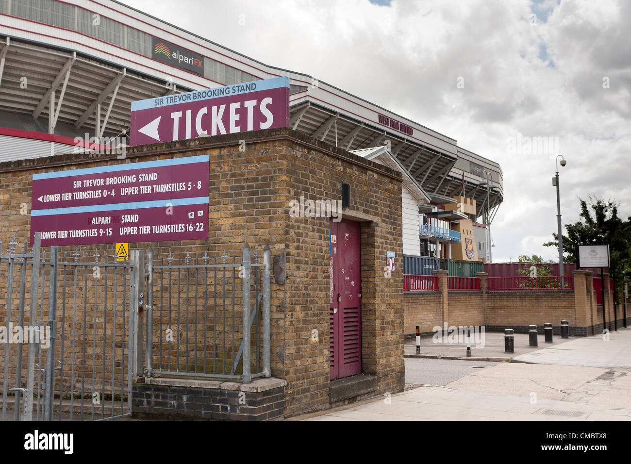 Sign for the ticket office of West Ham United Football Club, Upton Park, London. Also known as the Boleyn Ground. Stadium in background. Stock Photo