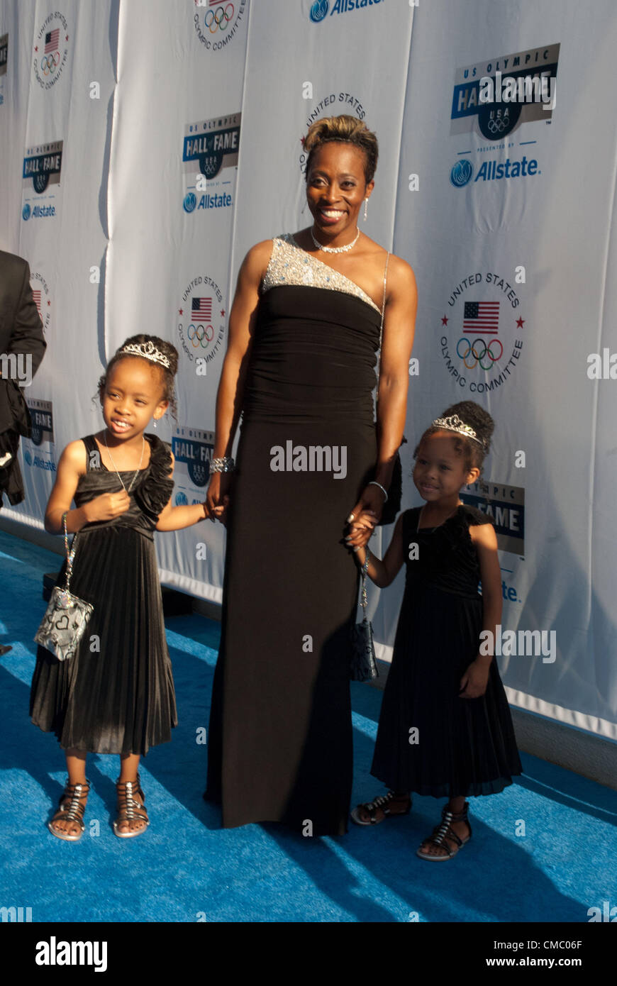 Gail Devers with daughters Karsen and Legacy walk down the blue carpet  before entering the Harris Theater in Chicago where Gail was inducted into  the U.S. Olympic Hall of Fame on July
