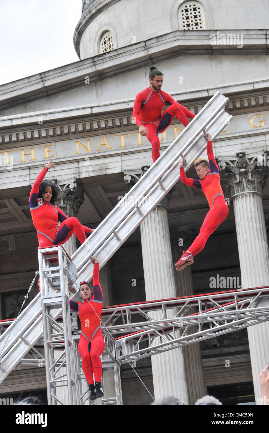 London, UK. 15th July 2012. Performers on the spinning ladder. One Extraordinary Day, Surprises: Streb. Choreographer Elizabeth Streb and her New York dance company 'Action Heroes' with their performance ASCENSION in front of the National Gallery. Stock Photo