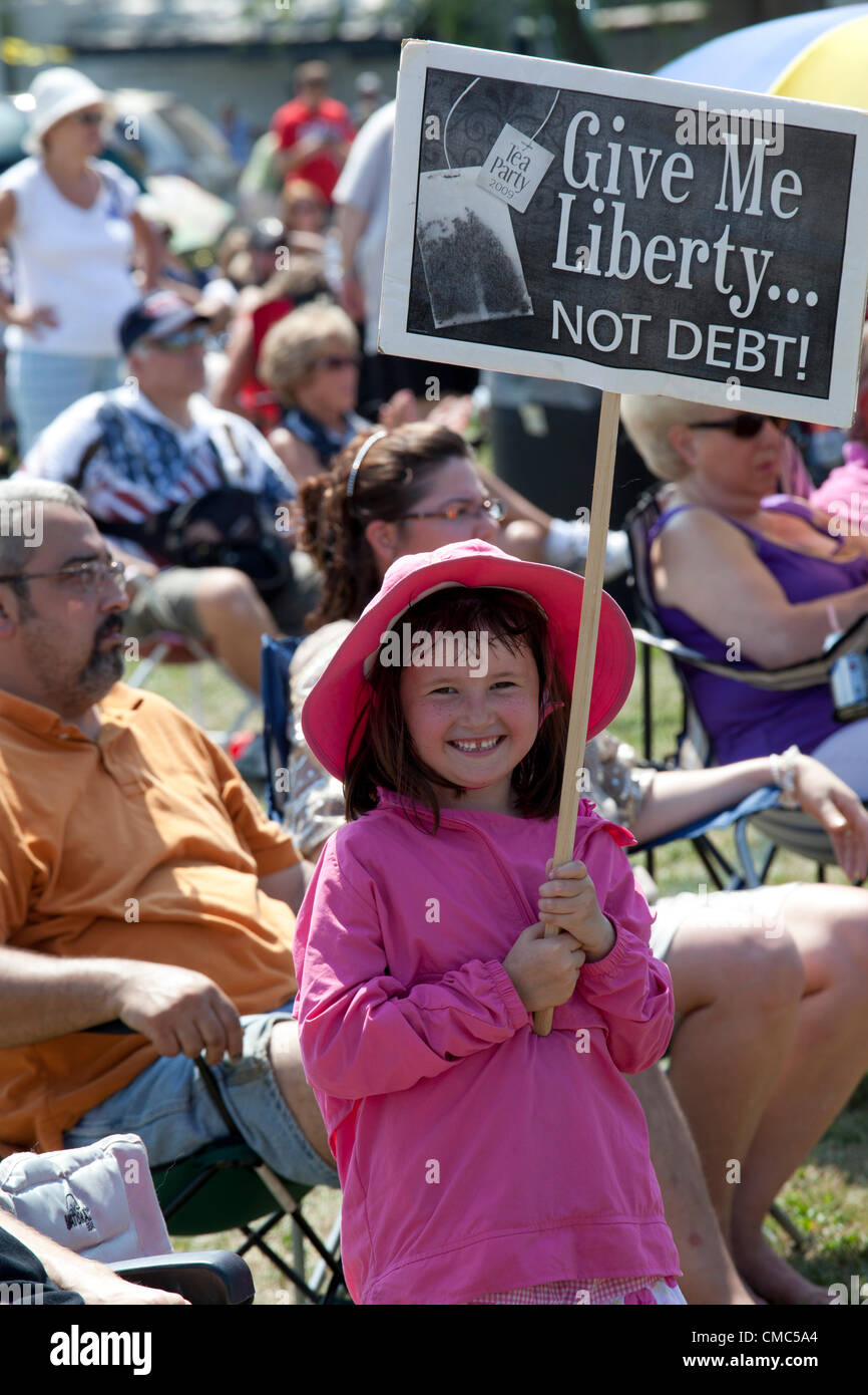 Belleville, Michigan - July 14, 2012 - A 'Patriots in the Park' rally, organized by the Tea Party and Americans for Prosperity. The rally was addressed by former Alaska Governor Sarah Palin. Six-and-a-half-year-old Abby carried a Tea Party sign. Stock Photo