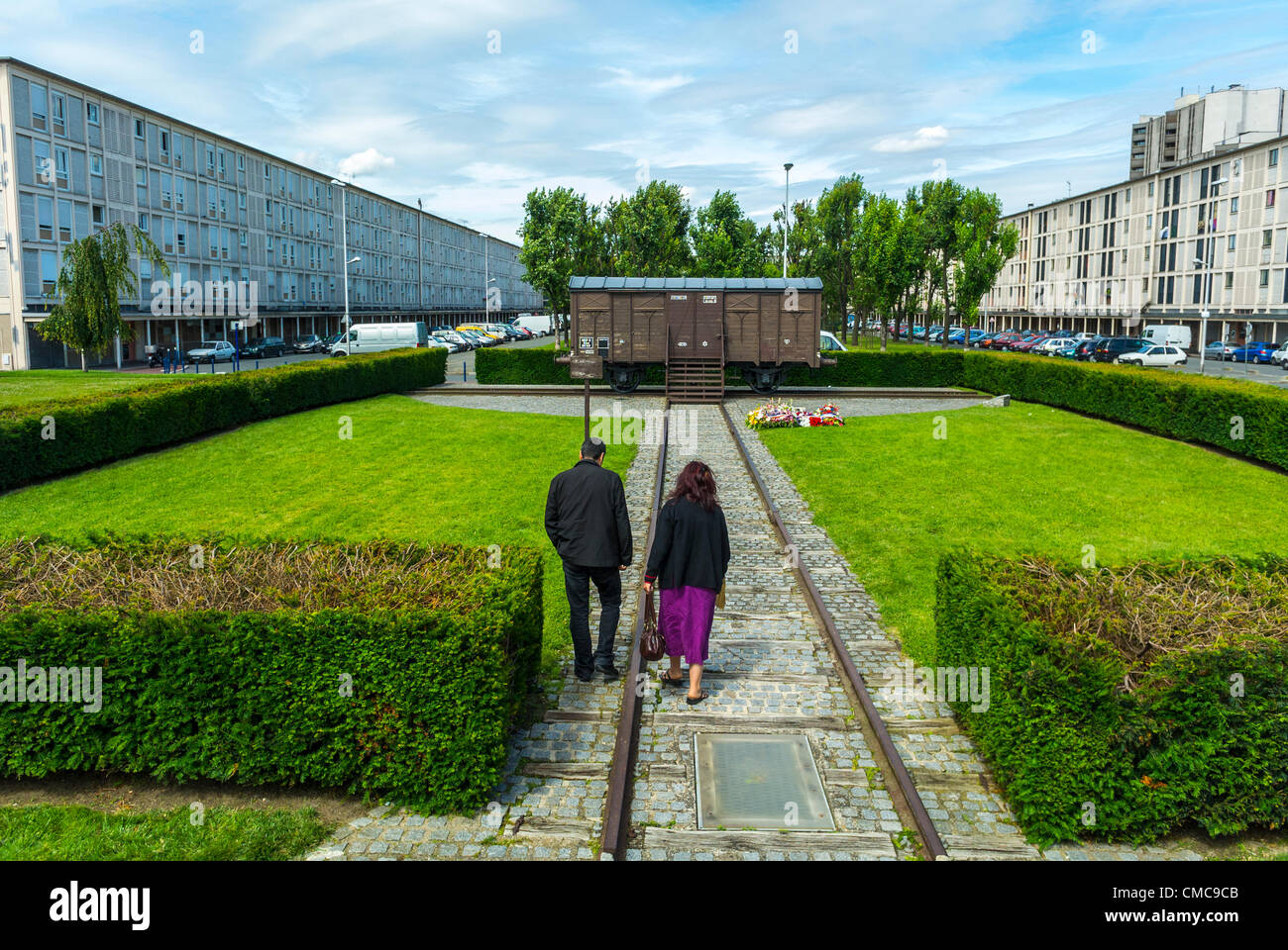 Drancy, France, Shoah Memorial in Suburbs, Camp Drancy, Holding Place, Where in WWII, Nazi Deportations of Jews and other Foreigners, 1941, to German Death Camps, took place, Couple Visiting Memorial Train, discrimination, never forget persecution of jews in europe, history nazism jews france, holocaust jews wwii, deportation trains Stock Photo