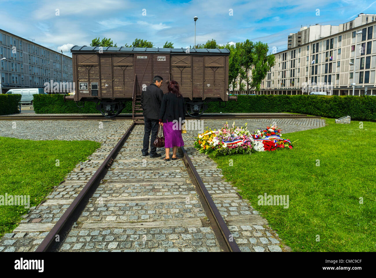 Drancy, France, Shoah Memorial in Suburbs, Camp Drancy, Holding Place, Where in WWII, Nazi Deportations of Jews and other Foreigners, 1941, to German Death Camps, took place, Couple Visiting Memorial Train, discrimination, history jews france, holocaust jews wwii, deportation trains Stock Photo
