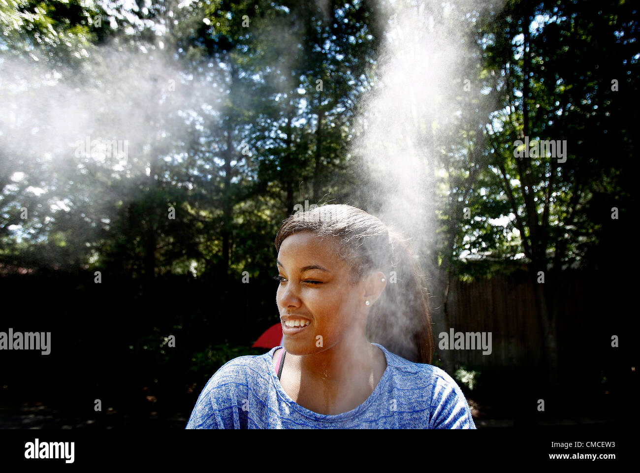July 17, 2012 - Memphis, TN, U.S. - July 17, 2012 - Maryah Smith, 16, (cq) cools off in a misting hose at the Memphis Zoo during a hot Tuesday afternoon. The Memphis Zoo offers free admission to Tennessee residents on Tuesday afternoons from 2 p.m. to close. (Credit Image: © Mark Weber/The Commercial Appeal/ZUMAPRESS.com) Stock Photo