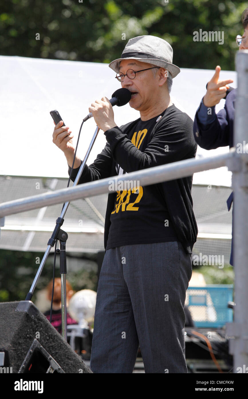 July 16, 2012, Tokyo, Japan - Ryuichi Sakamoto, Japan's renown musician and composer, addresses the crowd during an anti-nuclear rally in Tokyo on Monday, July 16, 2012. Tens of thousands of people, young and old, families and individuals packed Tokyo's Yoyogi Park for Japan's biggest anti-nuclear rally since the Fukushima disaster last year in growing protests against government moves to restart nuclear reactors. The assembly, dubbed '100,000 People's Assembly to say Goodbye to Nuclear Power Plants,' drew a crowd of around 170,000 people, according to organizers. (Photo by Hiroyuki Ozawa/AFLO Stock Photo