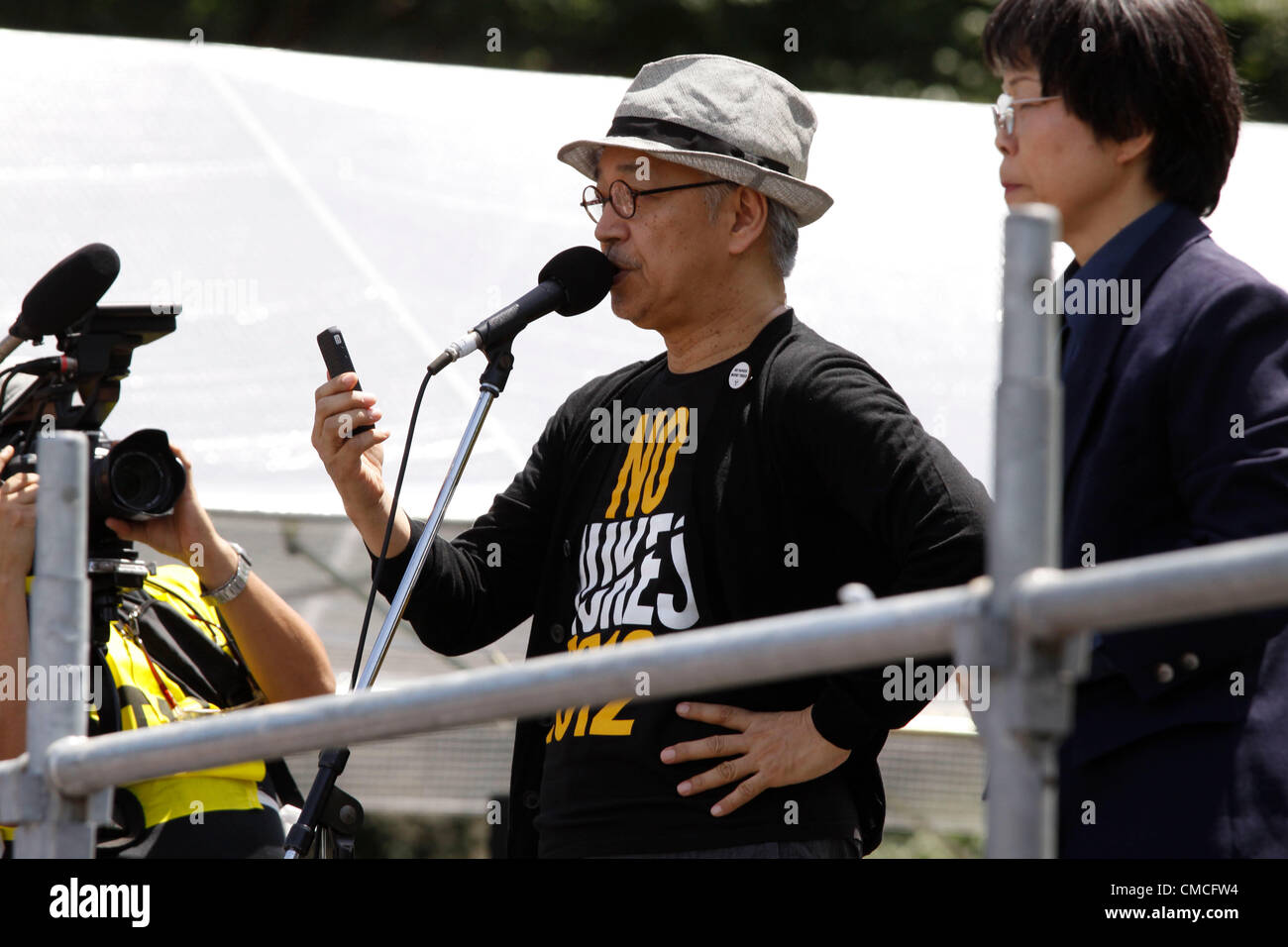 July 16, 2012, Tokyo, Japan - Ryuichi Sakamoto, Japan's renown musician and composer, addresses the crowd during an anti-nuclear rally in Tokyo on Monday, July 16, 2012. Tens of thousands of people, young and old, families and individuals packed Tokyo's Yoyogi Park for Japan's biggest anti-nuclear rally since the Fukushima disaster last year in growing protests against government moves to restart nuclear reactors. The assembly, dubbed '100,000 People's Assembly to say Goodbye to Nuclear Power Plants,' drew a crowd of around 170,000 people, according to organizers. (Photo by Hiroyuki Ozawa/AFLO Stock Photo