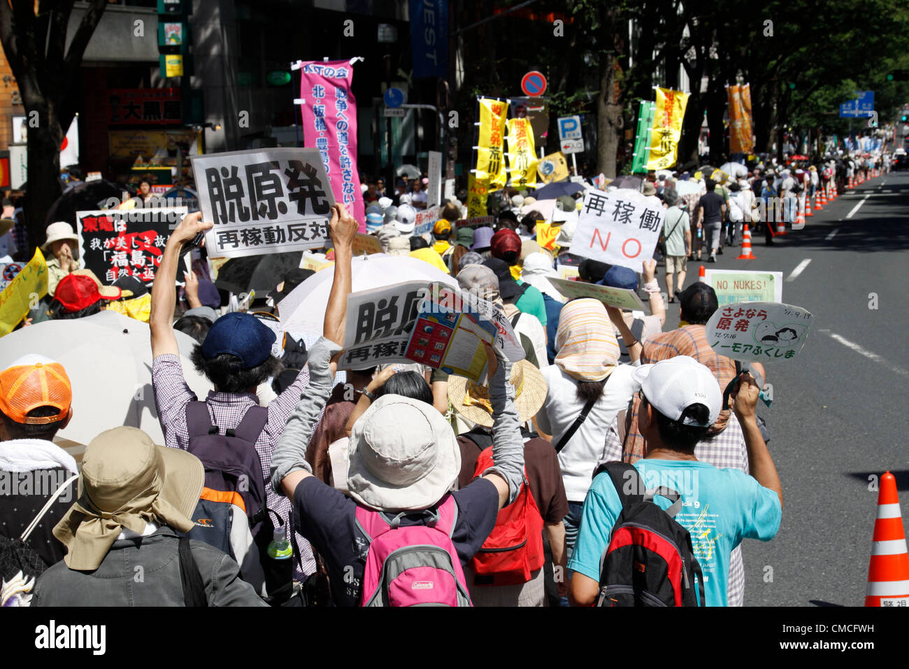July 16, 2012, Tokyo, Japan - Protesters march on a street during an anti-nuclear rally in Tokyo on Monday, July 16, 2012. Tens of thousands of people, young and old, families and individuals packed Tokyo's Yoyogi Park for Japan's biggest anti-nuclear rally since the Fukushima disaster last year in growing protests against government moves to restart nuclear reactors. The assembly, dubbed '100,000 People's Assembly to say Goodbye to Nuclear Power Plants,' drew a crowd of around 170,000 people, according to organizers. (Photo by Hiroyuki Ozawa/AFLO) [2178] -ty- Stock Photo