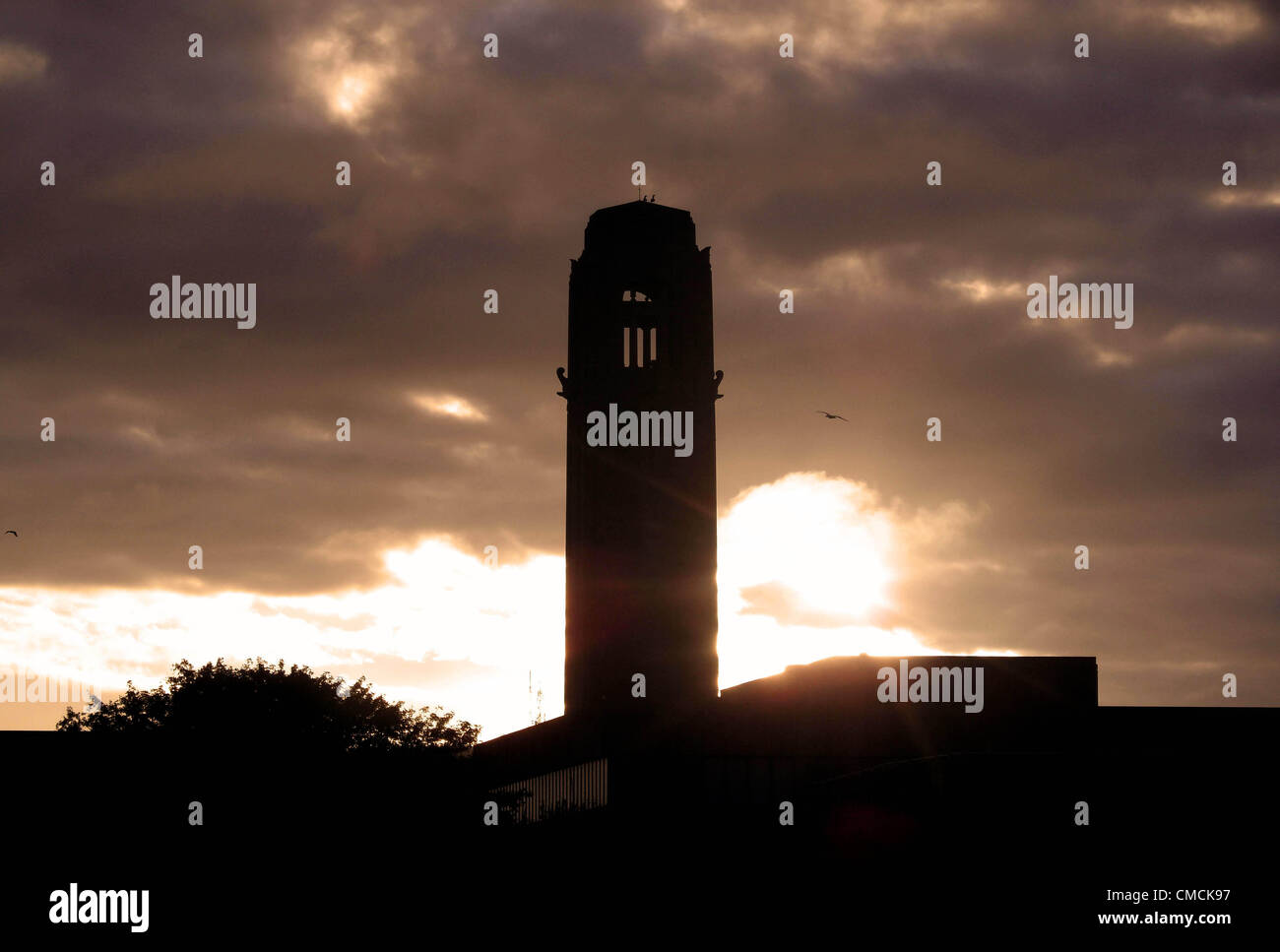 Swansea - UK - 19th July 2012 :  The sky glows as dawn breaks this morning over the Guildhall tower in the centre of Swansea, UK. Stock Photo