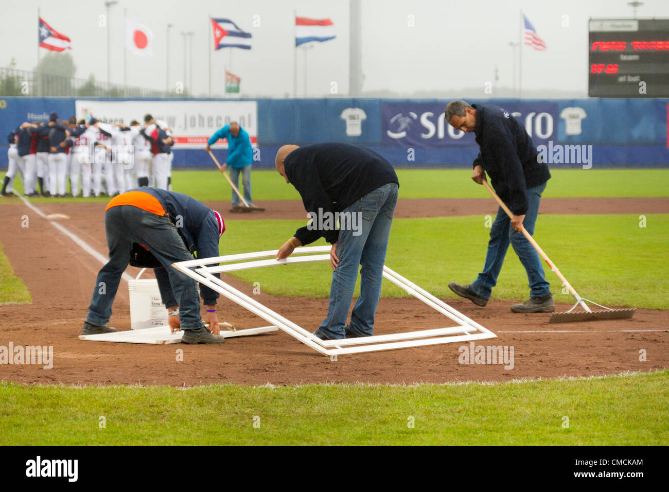 HAARLEM, THE NETHERLANDS, 18/07/2012. The field crew prepares the home plate before the match USA versus Chinese Taipei at the Haarlem Baseball Week 2012. Stock Photo