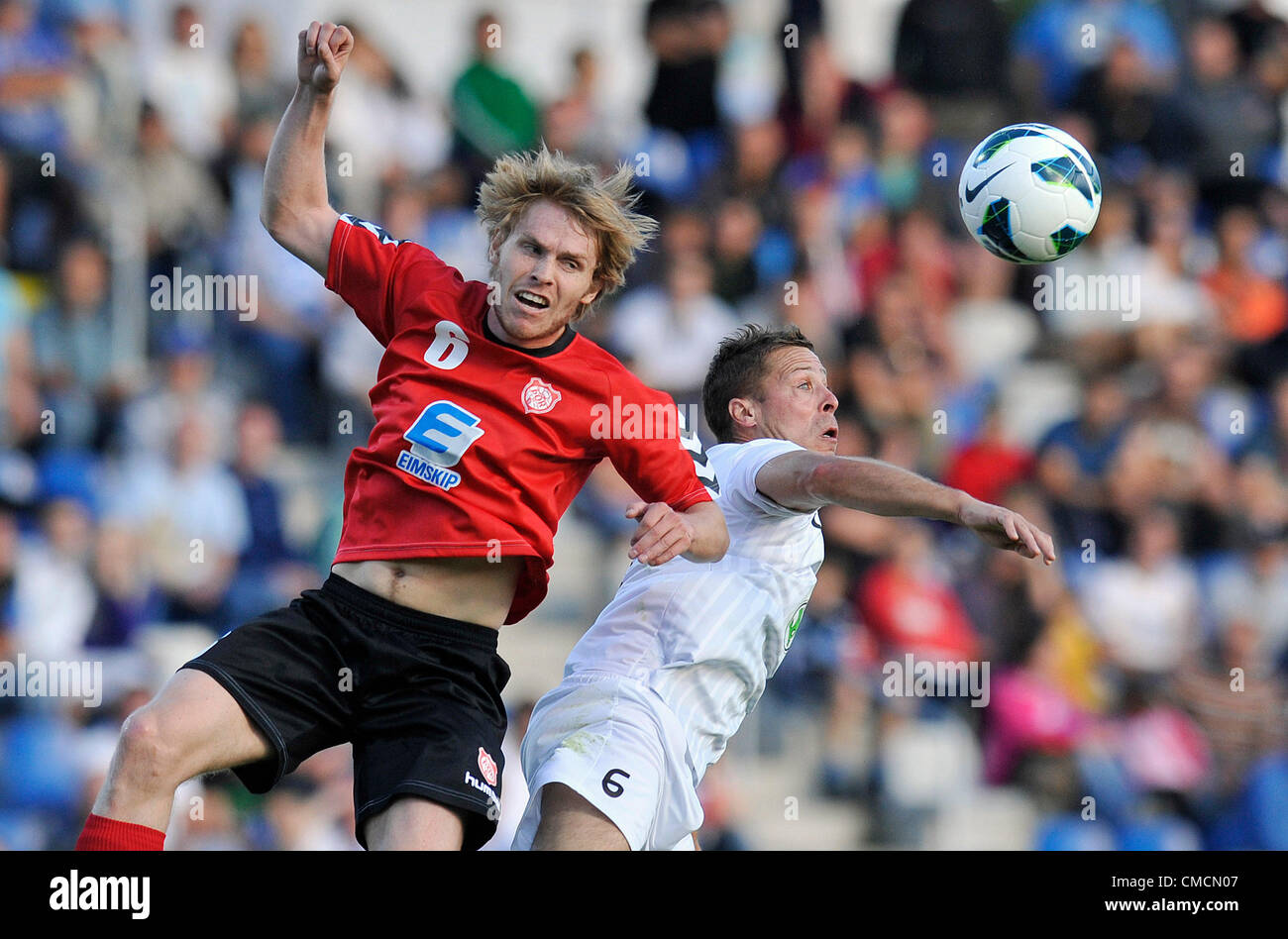 The European Football League, 2nd qualifying round opening match, FK Mlada Boleslav vs Thor Akureyri, Mlada Boleslav, Czech Republic, on Thursday, July 19, 2012. Radek Sirl of Mlada Boleslav, right, and Armann Aevarsson of Thor Akureyri. (CTK Photo/Radek Petrasek) Stock Photo