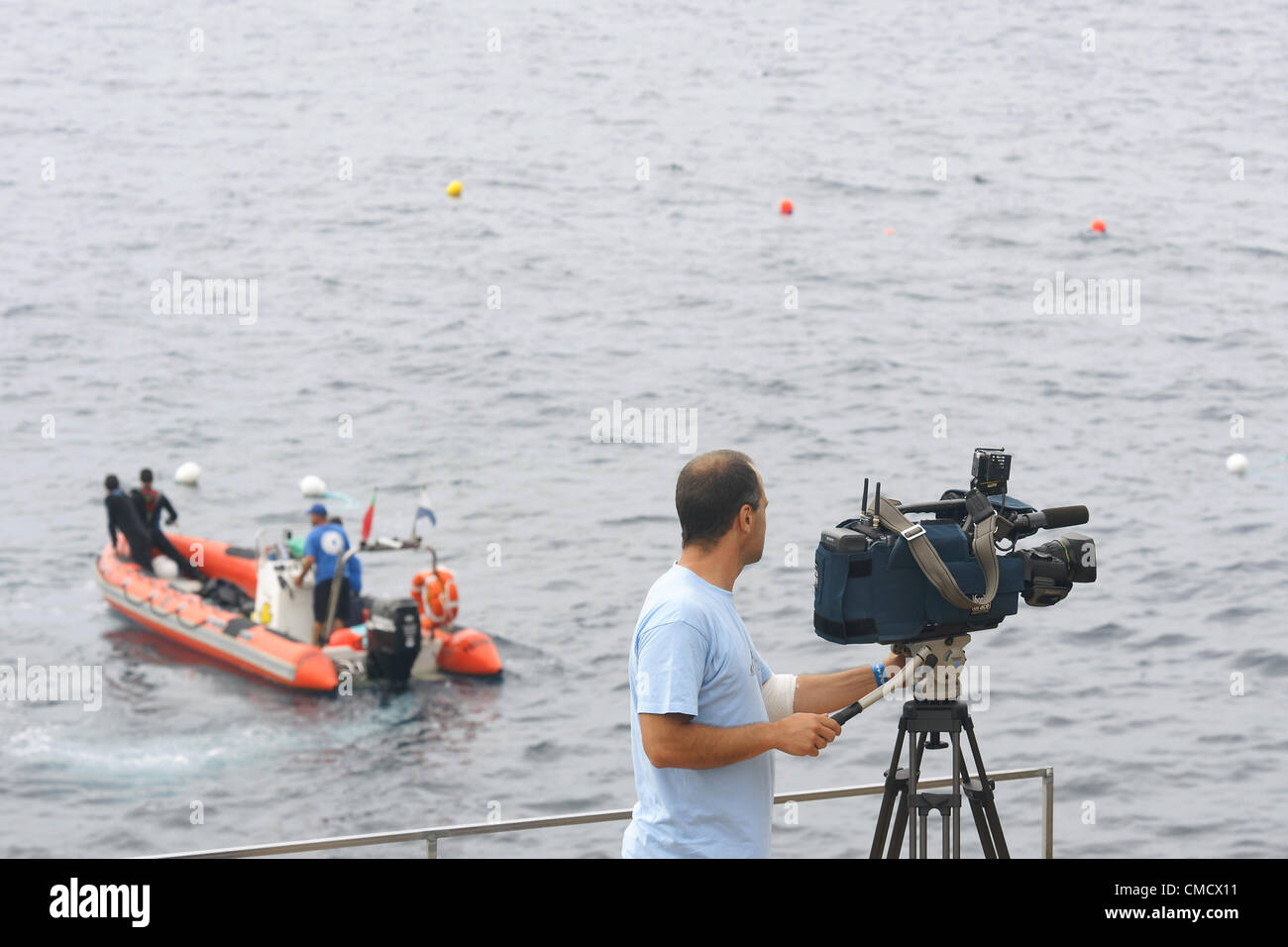 Franca do Campo, Azores. 20th July, 2012. Red Bull Cliff Diving, Day I: pratice at 28 meters. Police boat and tv media reporter Stock Photo