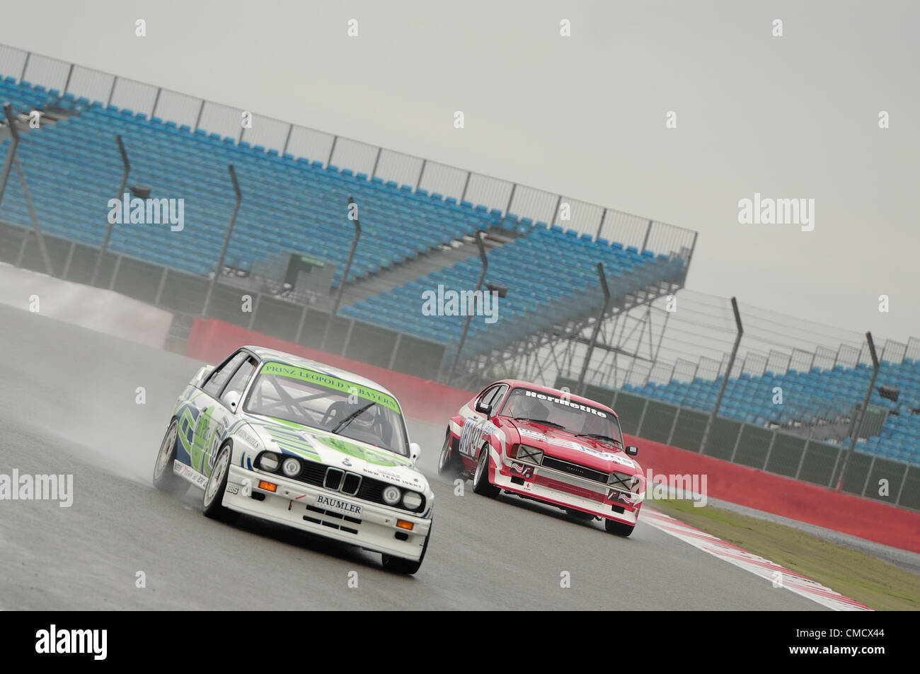 20th July 2012, Silverstone, UK  Tom Pochciol's Ford Capri, and Don Grice's BMW M3 DTM in the rain during qualifying for the Fujifilm Touring Car Trophy 1970-2000 race at Silverstone Classic 2012 Stock Photo