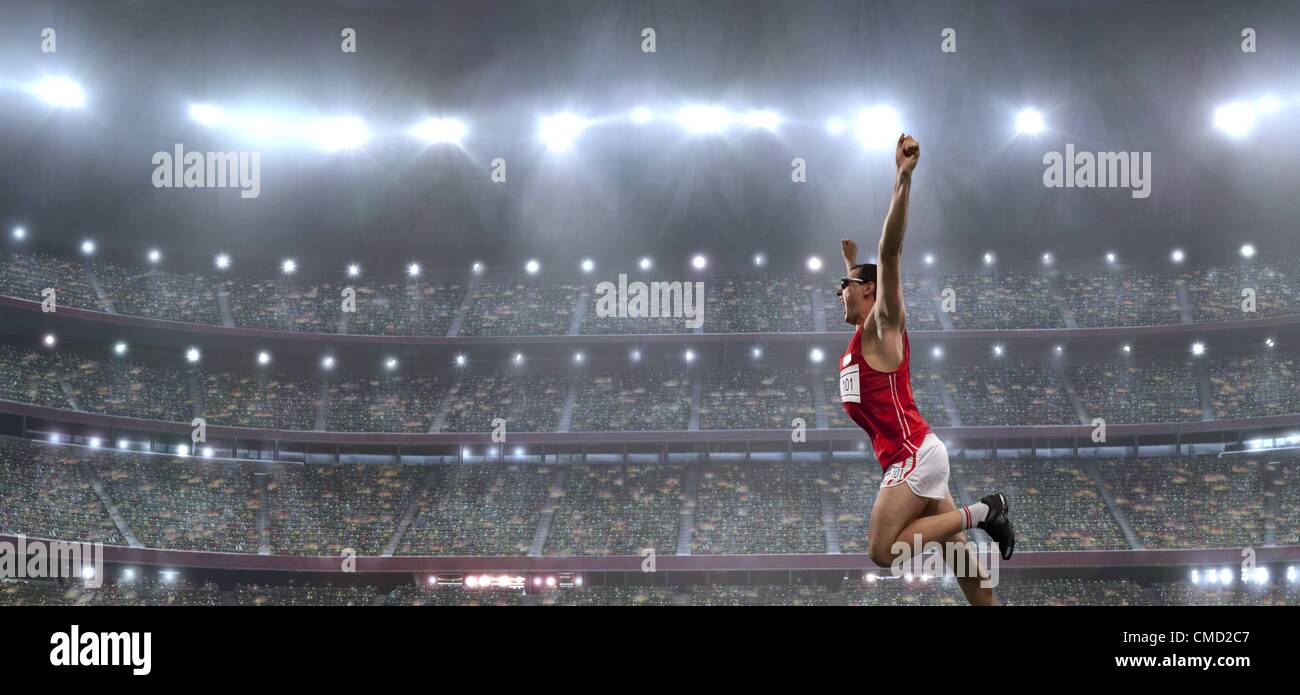 08.11.2011. Model released picture of a male athlete celebrating his victory in an athletics stadium in front of a large crowd of fans Stock Photo