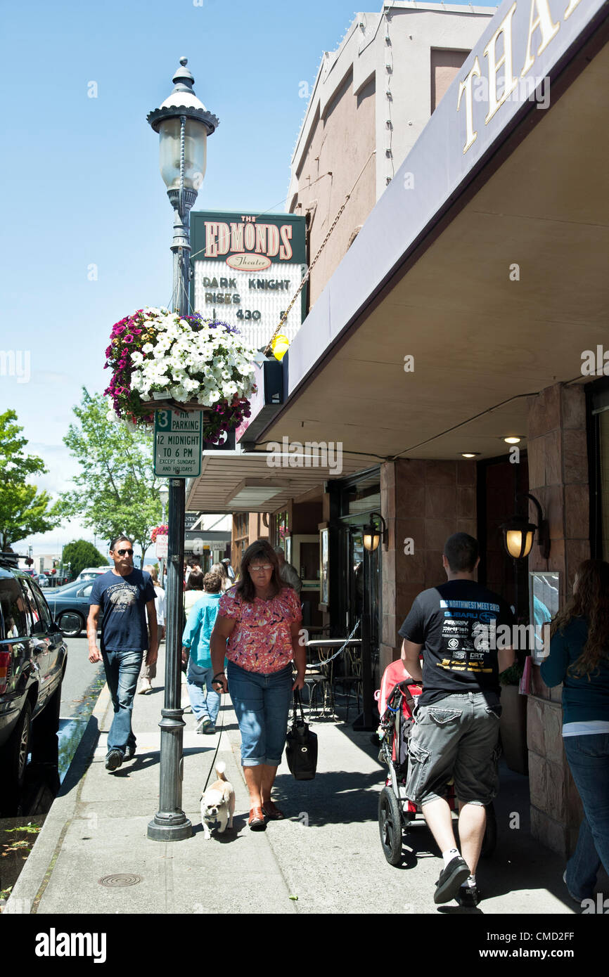 beautiful peaceful Saturday afternoon outside movie theater on the opening weekend showing of Dark Night Rises in Edmonds Washington USA. Concurrently Edmonds flags are flown at half mast  in memoriam for victims of the previous day's shooting at midnight showing of the film in Aurora Colorado Stock Photo