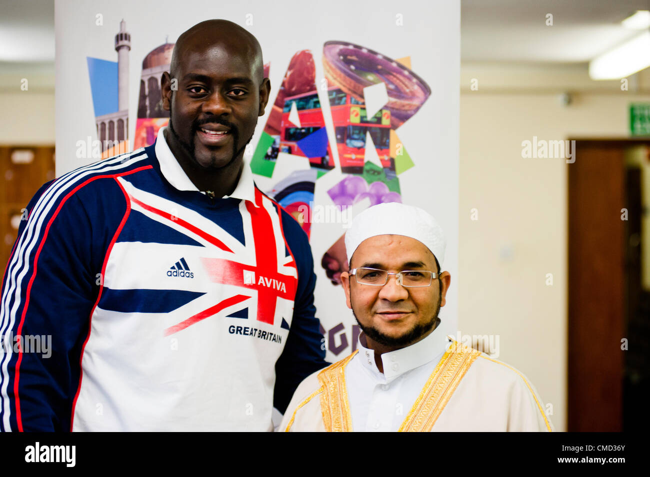 London, UK - 21 July 2012: Team GB Olympic discus thrower Abdul Buhari poses for a picture with Sheikh Khalifa Ezzat, Head Imam of the London Central Mosque (ICC) in Regents Park during the Ramadan Iftar 2012 celebrations Stock Photo