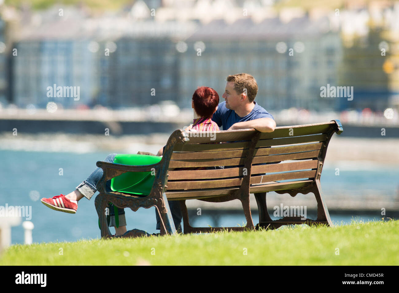 People enjoying the warm sunny weather at the seaside in Aberystwyth