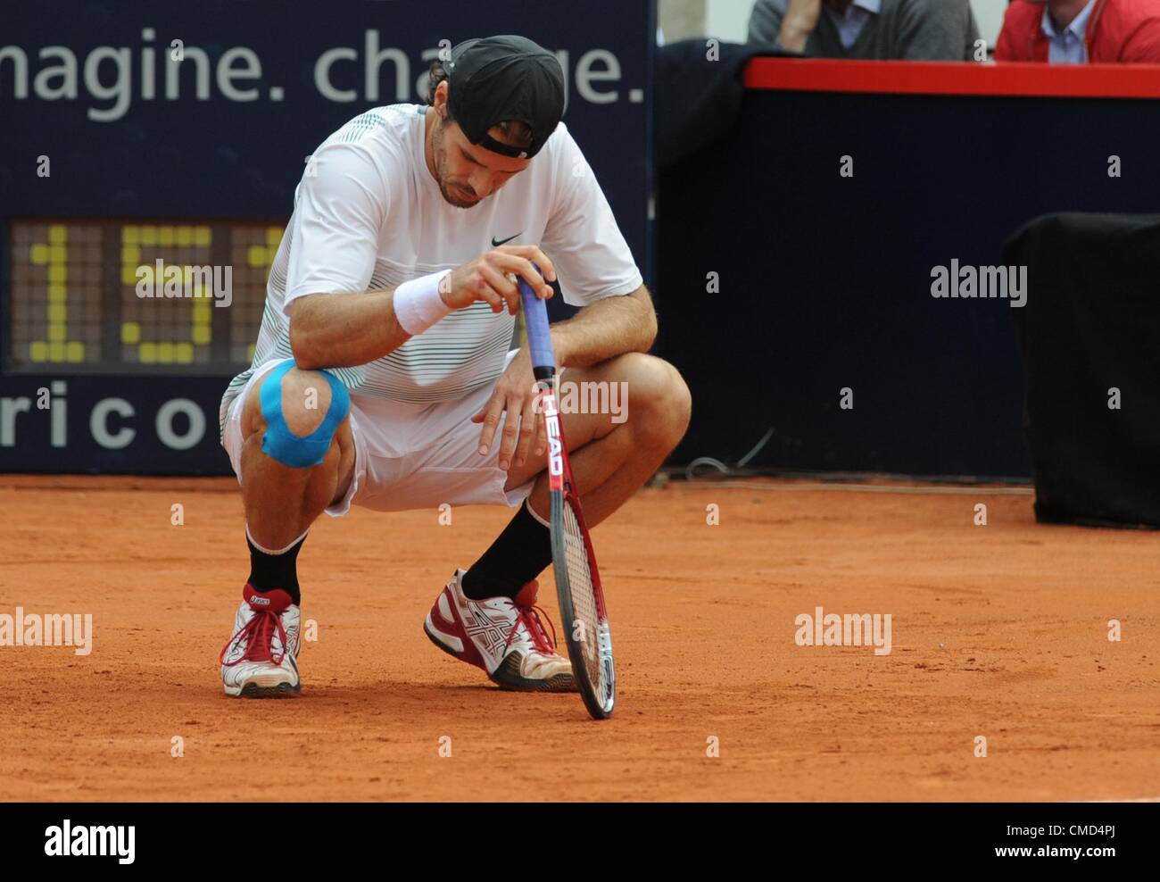 22.07.2012. Hamburg, Germany. German tennis player Tommy Haas squats during  the final of the ATP