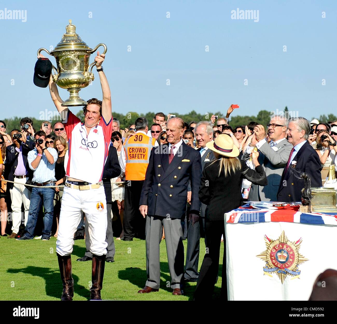 22.7.2012. Egham, Surrey, England. Luke Tomlinson (7, captain) of Audi England lifts the Coronation CupThe AUDI International Polo featuring the Coronation Cup at Guards Polo Club, Smith's Lawn, Windsor Great Park, Egham, Surrey, England on 22 July 2012. Stock Photo