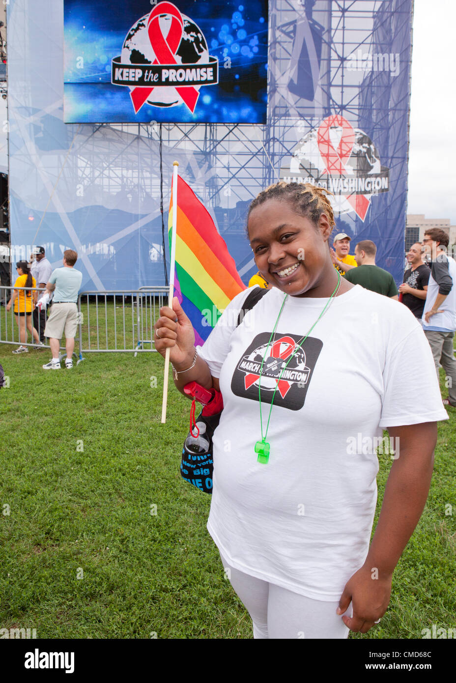 A woman holds up a rainbow flag before the AIDS march - July 22, 2012, Washington, DC USA Stock Photo