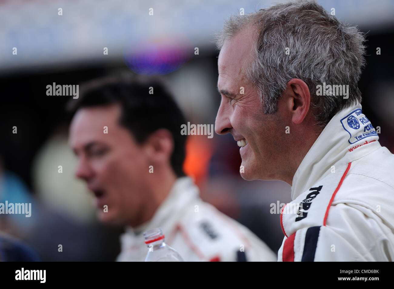 21st July 2012, Silverstone, UK.  Former footballer Steve Ball (foreground) and Radio One DJ Dave Vitty (background) after the Silverstone Classic Celebrity Race Stock Photo