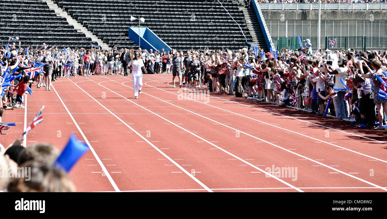 23/07/12 LONDON, UK: Sprinter Marlon Devonish runs a lap of Crystal Palace athletics stadium with the Olympic torch. Stock Photo
