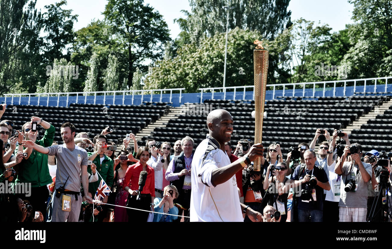 23/07/12 LONDON, UK: Sprinter Marlon Devonish stands for the press at Crystal Palace athletics stadium with the Olympic torch. Stock Photo