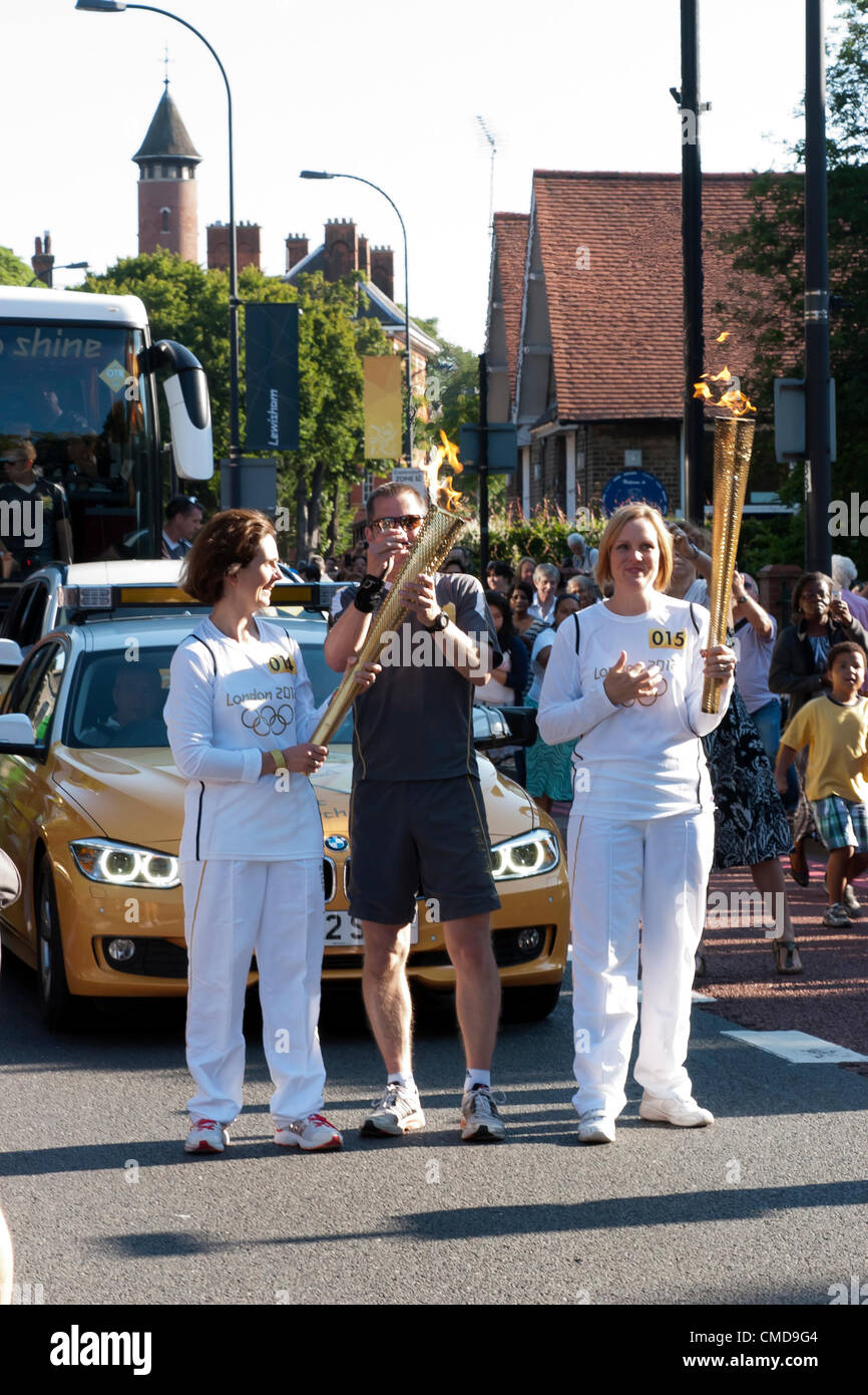 Handover of the Olympic Torch to Jaime Minter-Green (right), at Ladywell, Lewisham Stock Photo