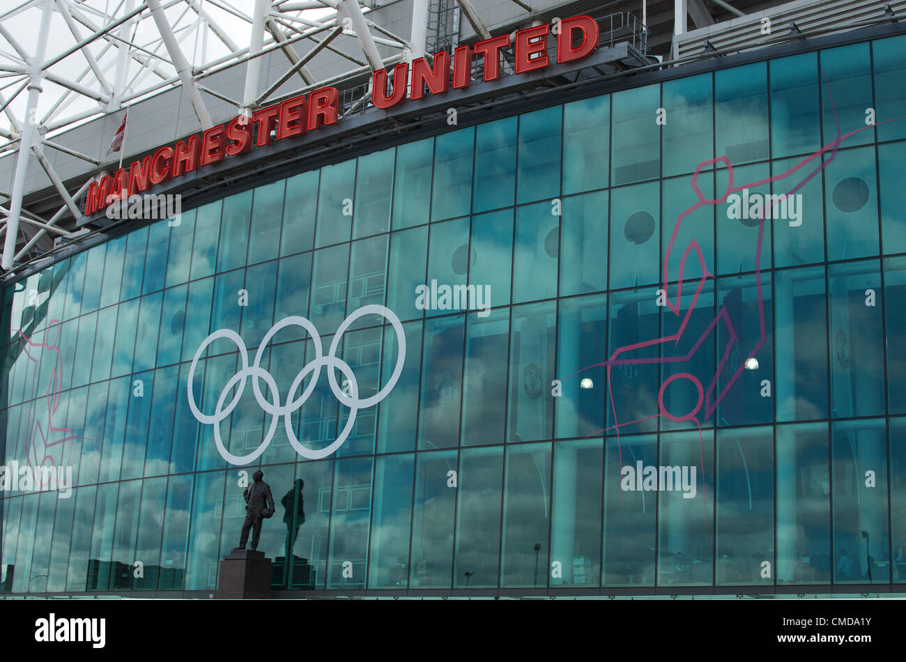 Manchester United's ground, Old Trafford, has the London Olympic rings above the statue of Sir Matt Busby, former manager, in readiness for its first matches on 25/07/2012 between the Inited Arab Emirates and Uruguay, followed by Great Britain against Senegal. Stock Photo