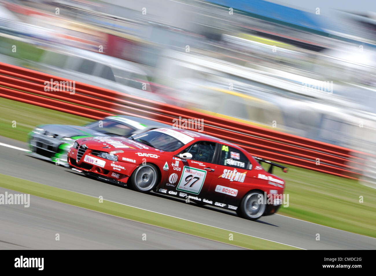 22nd July 2012, Silverstone, UK.  Neil Smith's Alfa Romeo 156 attempts to overtake Richard Hawken's Nissan Primera during the Fujifilm Touring Car Trophy 1970 - 2000 race at Silverstone Classic 2012 Stock Photo