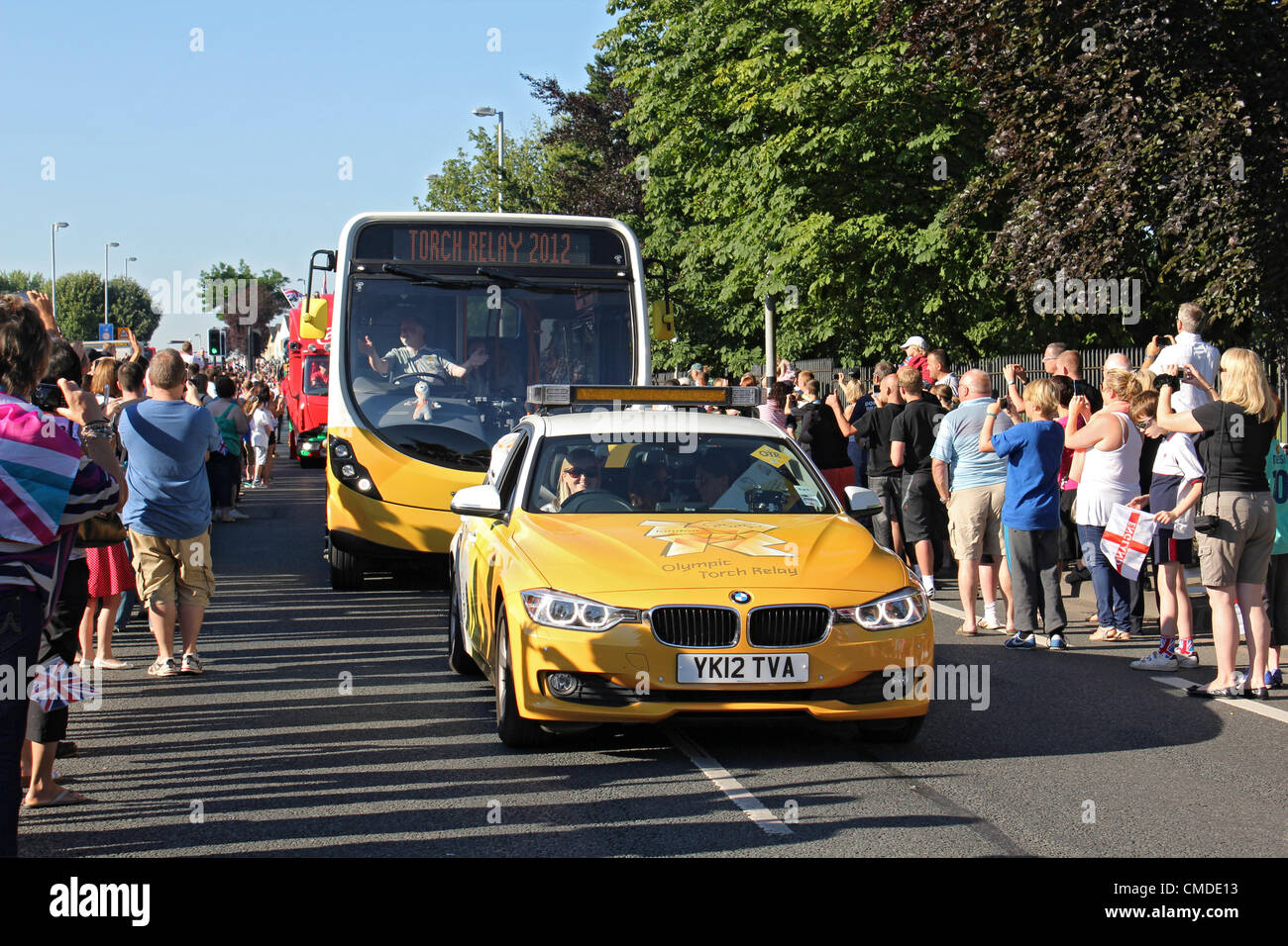 24 July 2012. Hook Road, Chessington, Surrey UK. 8.30am. Olympic Torch Relay day 67. The official entourage of cars and buses leads the way through excited supporters. Credit:  Julia Gavin / Alamy Live News Stock Photo
