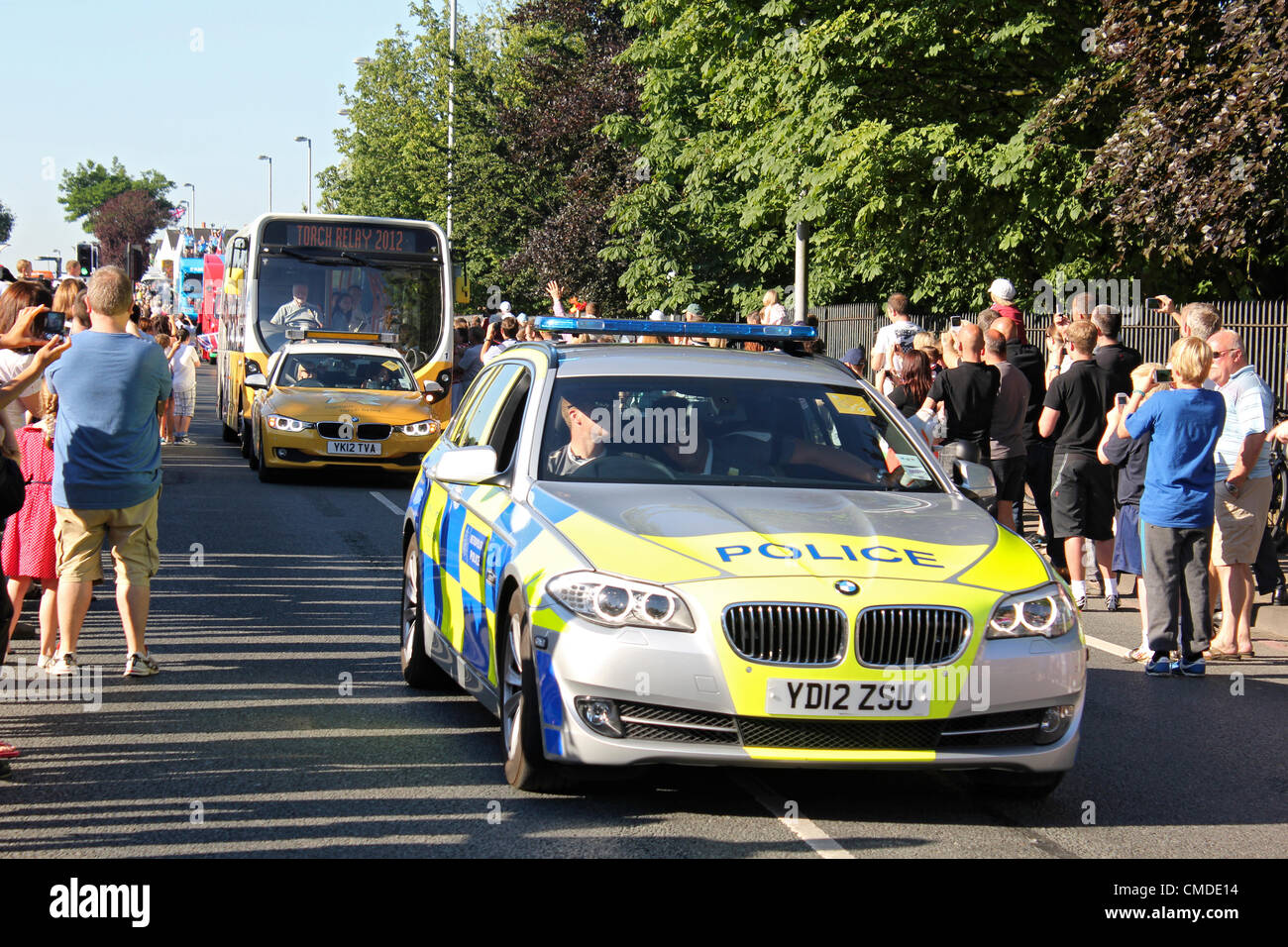 24 July 2012. Hook Road, Chessington, Surrey UK. 8.30am. Olympic Torch Relay day 67. A police car clears the way for the official entourage of cars and buses ahead of the tourch bearer. Credit:  Julia Gavin / Alamy Live News Stock Photo