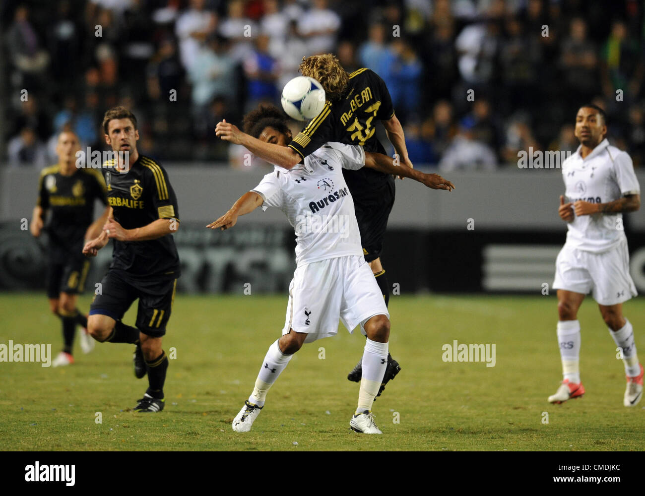 USA. 24.07.2012. Los Angeles, California.  Tottenham Hotspur (32) Benoit Assou-Ekotto and Galaxy (32) Jack McBean get tangled up while going for the ball during an international friendly soccer match between Tottenham Hotspur and the Los Angeles Galaxy at the Home Depot Center in Carson, CA. Stock Photo
