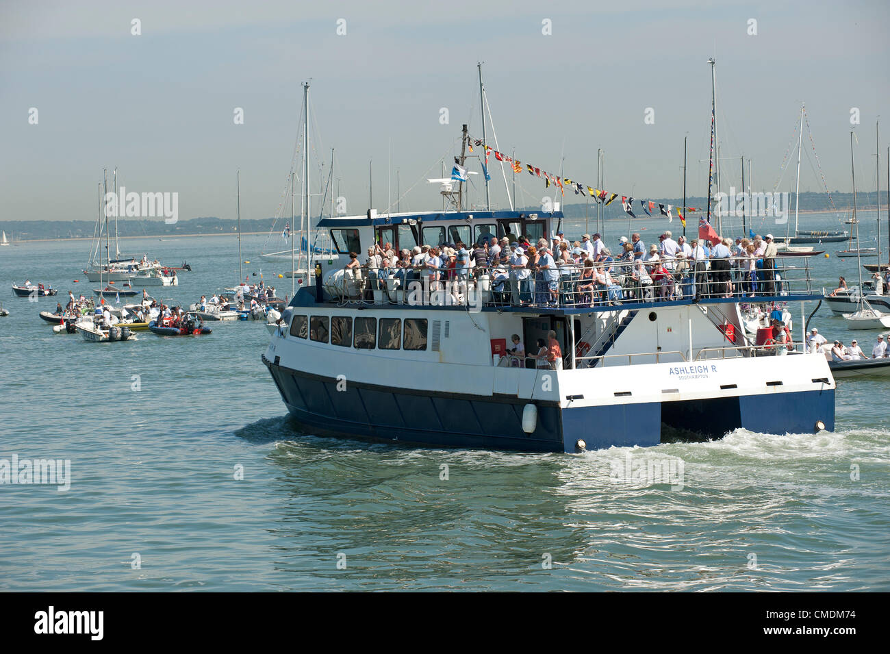Spectators crowded on a boat tour aboard The Ashleigh trip vessel in Cowes Harbour waiting to see the Queen on the last day of her Diamond Jubilee tour Stock Photo