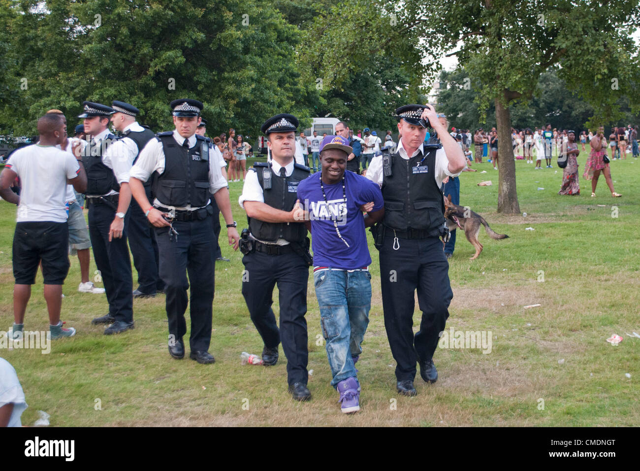 London, UK. 25/07/12. A youth is arrested for a breach of the peace due to  an argument with officers, after a second night of violence in Hyde Park.  Police officers, including officers
