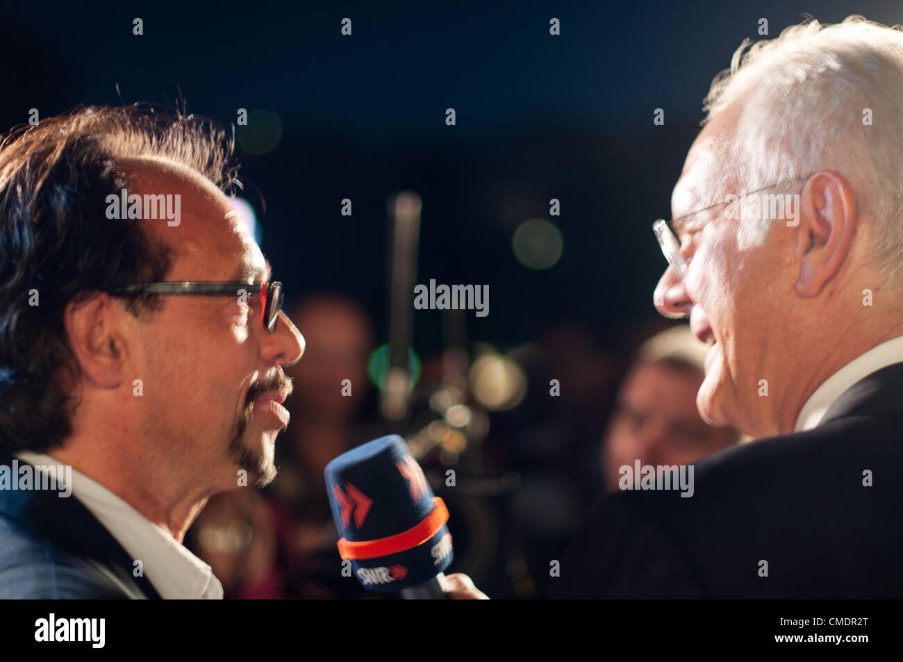 STUTTGART, GERMANY - JULY 25: Harald Schmidt, the most famous German talkmaster, is interviewing comedian Christoph Sonntag as a guest at the public viewing of the premiere of Mozart´s opera “Don Giovanni” in front of the Opera building in Stuttgart, Germany on July 25, 2012. Stock Photo